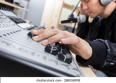 Hand Of Asian Handsome DJ, Producer Working On Digital Studio Mixer For Radio, TV Broadcasting Background