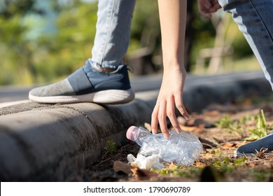 Hand of asian people is picking up trash,litter on the public floor,child girl was bending down to collect plastic bottle garbage in the park,volunteer community service,save earth,environment concept - Powered by Shutterstock