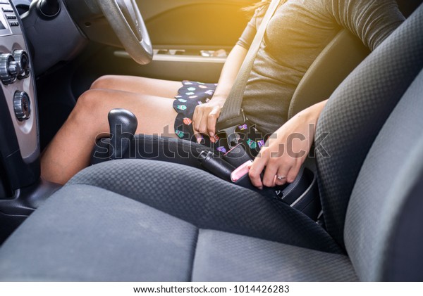 Hand asian woman driver using seat belt\
in car,Transportation safty and vehicle\
concept
