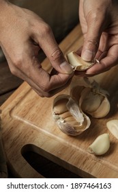 Hand of asian women peeling garlic at home in kitchen.  - Shutterstock ID 1897464163