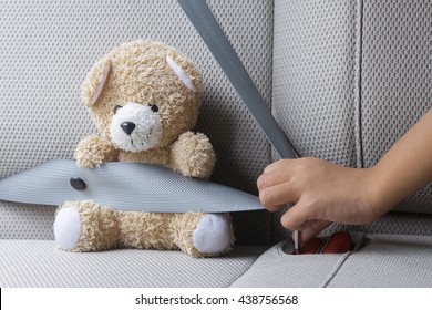 Hand of Asian Young Boy is Fastening Safety Seat Belt to Teddy Bear Stuffed .Safety Concept . Insurance Concept . - Powered by Shutterstock