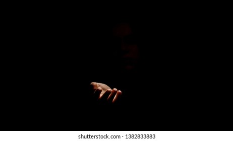 Hand asking help from darkness, concept of concealment of human rights abuses