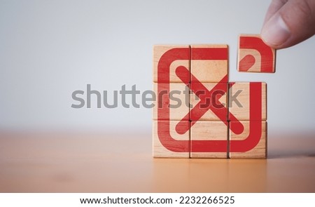 Hand assembly red tick mark which print screen on wooden cube block t , Approve and reject business and document concept.