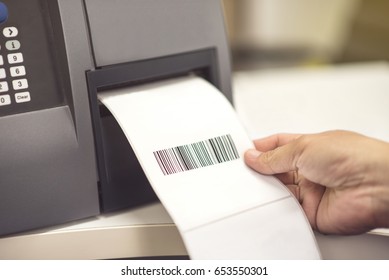 Hand and barcode label printer. Printing Barcode - Shutterstock ID 653550301