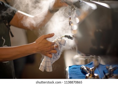 hand of barista cleaning streaming coffee machine in daily use by streaming pressure - Powered by Shutterstock