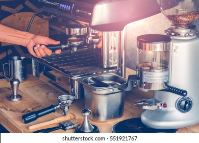 Hand of Barista put a portafilter to espresso machine for brewing coffee - Powered by Shutterstock