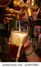 Hand Bartender Pouring Large Lager Beer. Light Cold Filtered Beer In Glass Beaker.