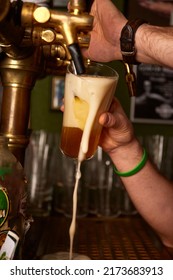 Hand Bartender Pouring Large Lager Beer. Light Cold Filtered Beer In Glass Beaker.