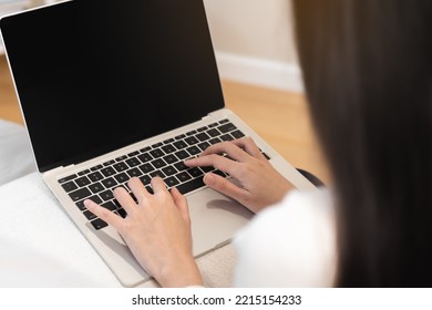 Hand Of Beautiful Asian Young Business Woman Looking On Screen Web, Using Laptop Computer, Sitting On Couch, Sofa At Home, Freelancer Working. Technology, Social Distance.