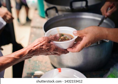 The Hand of the Beggars receives charity food from fellow human beings : The concept of humanitarianism : The hands of refugees have been aided by charity food to alleviate hunger : Feeding Concepts - Shutterstock ID 1432153412