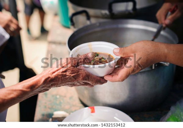The Hand of the Beggars receives charity food
from fellow human beings : The concept of humanitarianism : The
hands of refugees have been aided by charity food to alleviate
hunger : Feeding Concepts