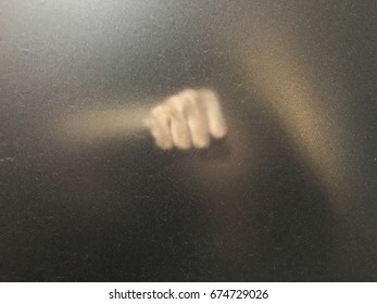 hand behind blur window