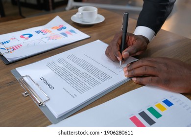 Hand of black business man signing a contract