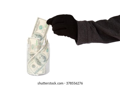 Hand With Black Glove Stealing Money From The Cookie Jar