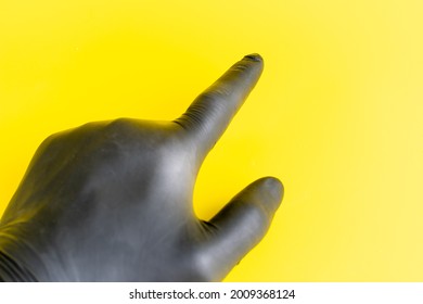 Hand in black gloves. Vinyl or latex gloves