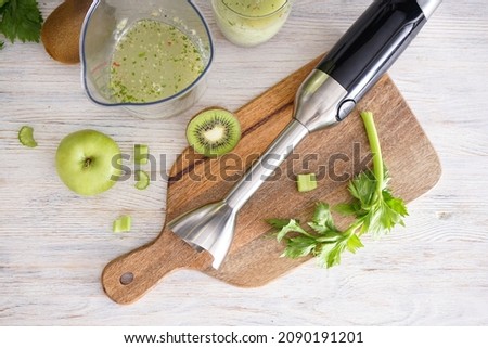 Hand blender for mixing organic raw fresh fruits for making vitamin diet smoothie, healthy food. Top view.
