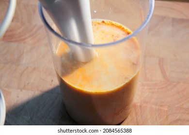 A Hand Blender That Stands In A Mug. In The Form Is Oat Milk And Banana For Making A Banana Shake.