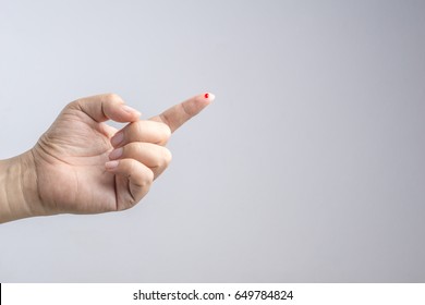 Hand with blood drop at finger from needle for sample testing on white background