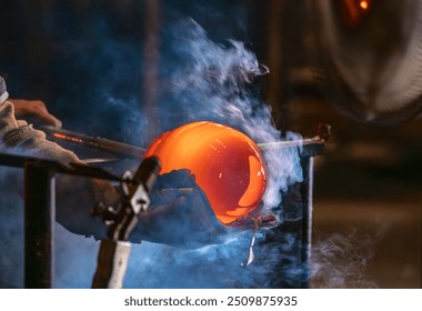 Hand blown glass manufacturing. Hard work of artistic glasser. - Powered by Shutterstock