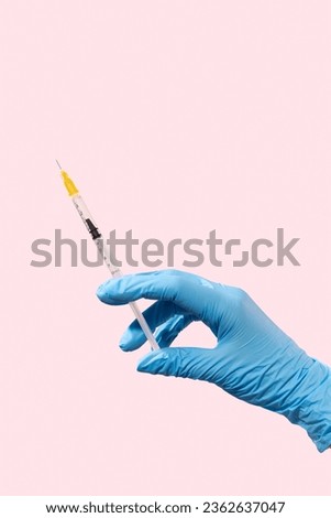 In a hand with a blue glove, a cosmetology syringe for injections, insulin in a pink background. Mesotherapy, rejuvenating procedures, botulinum toxin, contour plastic, biorevitalization