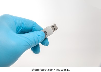 Hand In Blue Glove Holding Flash Drive