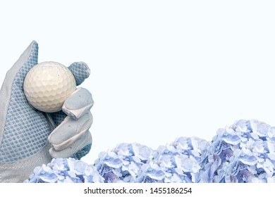 Hand In Blue Glove Is Holding Golf Ball On Blue Background With Hydrangea Flowers