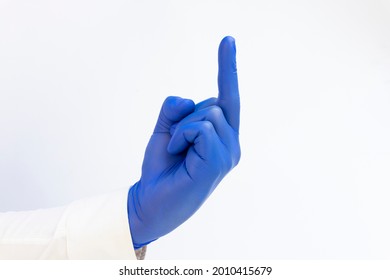 Hand In Blue Latex Glove Giving Middle Finger. White Background. Copy Space