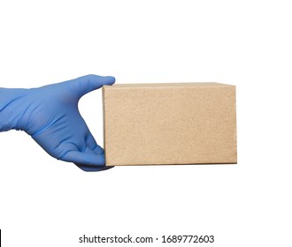 Hand In Blue Medical Glove Gives Cardboard Box.?oncept Of Safety Mail Goods Courier Delivery In Virus Or Coronavirus Quarantine. ?opy Space On White Background