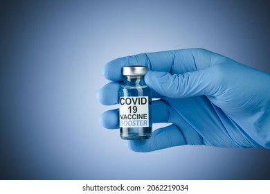 Hand In Blue Medical Gloves Holding A Vaccine Vial With Covid 19 Vaccine Booster Text, For Coronavirus Booster Shot.