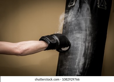 Hand of boxer and punching bag over yellow background - Powered by Shutterstock