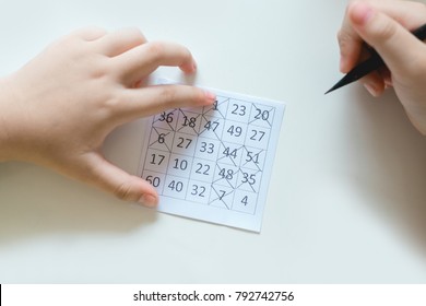 Hand Of Boy Playing Bingo Game