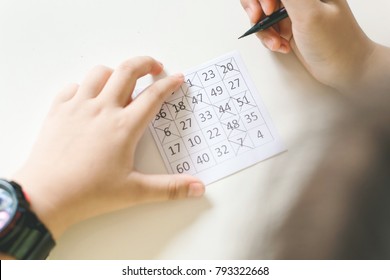 Hand Of Boy Playing Bingo Game