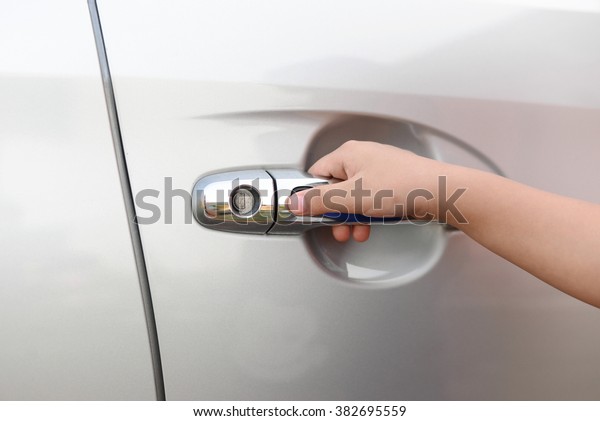 Hand boy
pushing button of car handle to open
car