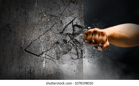 Hand breaking through the wall. Mixed media - Shutterstock ID 1078198010