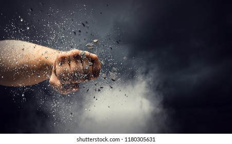 Hand breaking through the wall. Mixed media - Shutterstock ID 1180305631