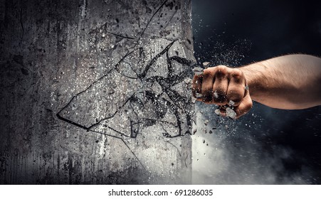 Hand breaking through the wall. Mixed media - Shutterstock ID 691286035