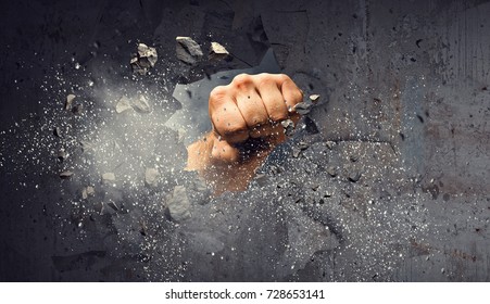 Hand breaking through the wall. Mixed media - Shutterstock ID 728653141