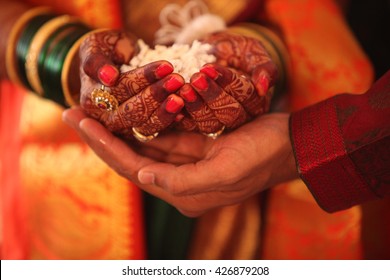 The hand of the bride held by a groom during a traditional ritual in an Indian Hindu Wedding