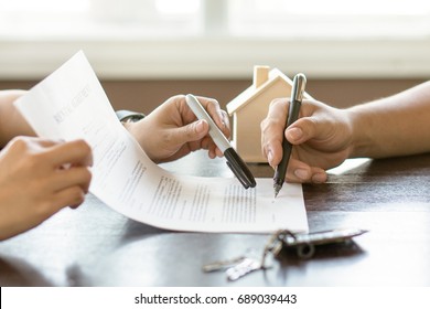 Hand of broker showing to client where to sign signature contract. - Shutterstock ID 689039443