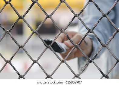 Hand With Brush Painting Metal Fence.