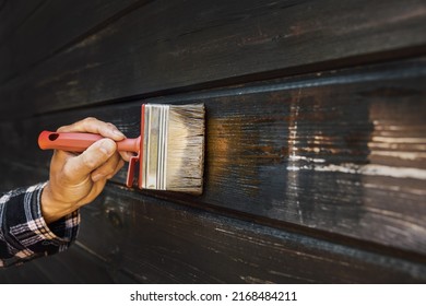 Hand With Brush Restore Paint Of Old Wooden House Exterior Wall