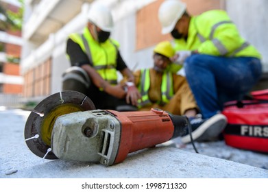 Hand Of Builder Worker Injury Bleeding, Accident In Work, Using Construction Power Tools Unsafe And Negligence With First Aid Team Support At Construction Site. Selection Focus On Power Tools.