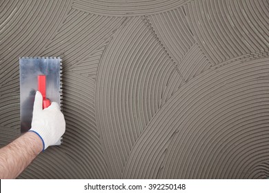 hand of builder worker  plastering  at wall