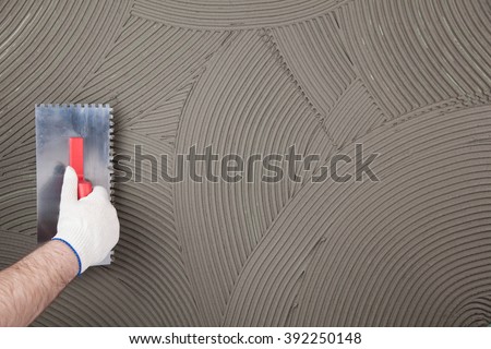 hand of builder worker  plastering  at wall