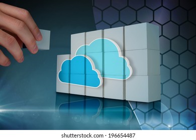 Hand building wall showing two blue clouds for cloud computing