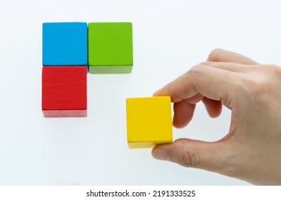 Hand To Building Wooden Cube Puzzle.