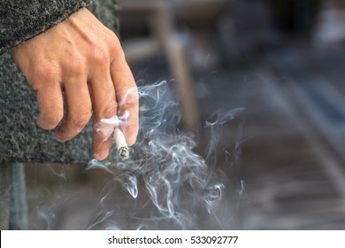 Hand With Burning Cigarette