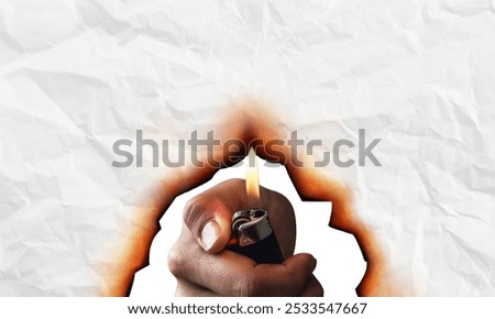Hand burning white paper using lighter, creating orange and black burn marks