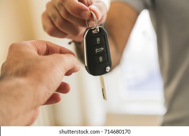 Hand of business man gives the car key