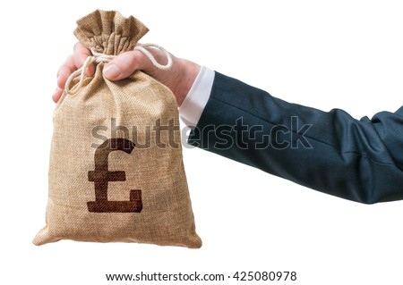 Hand of business man holds bag full of money with British pound sign. Isolated on white background.